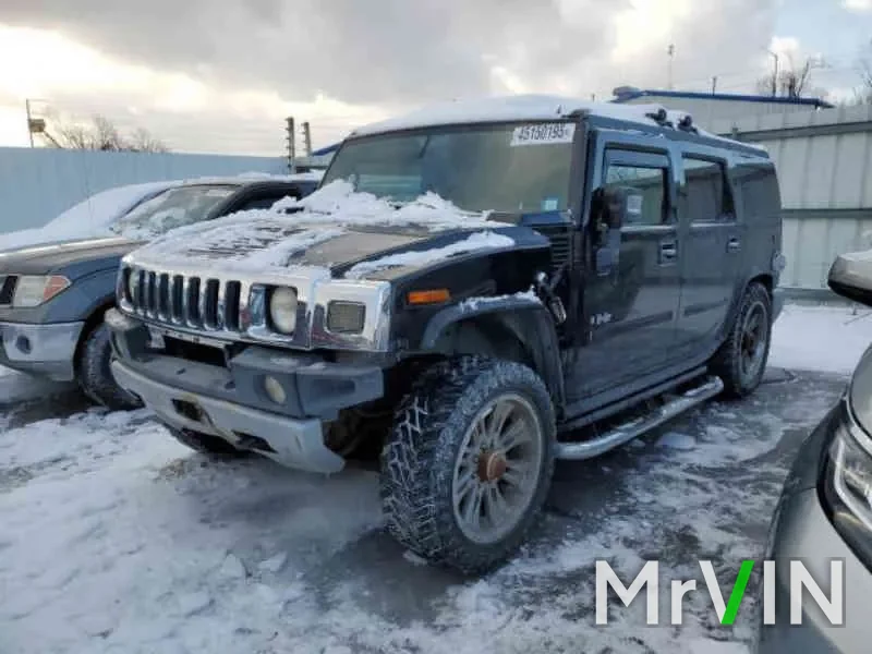 A damaged Hummer H2 in the snow at a salvage auction