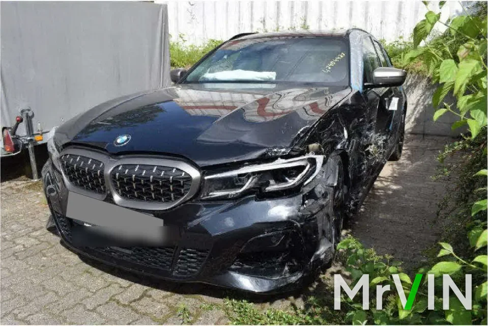 A black BMW M340d with front and side damage