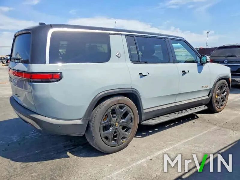 A grey Rivian R1S with no visible damage at a salvage auction